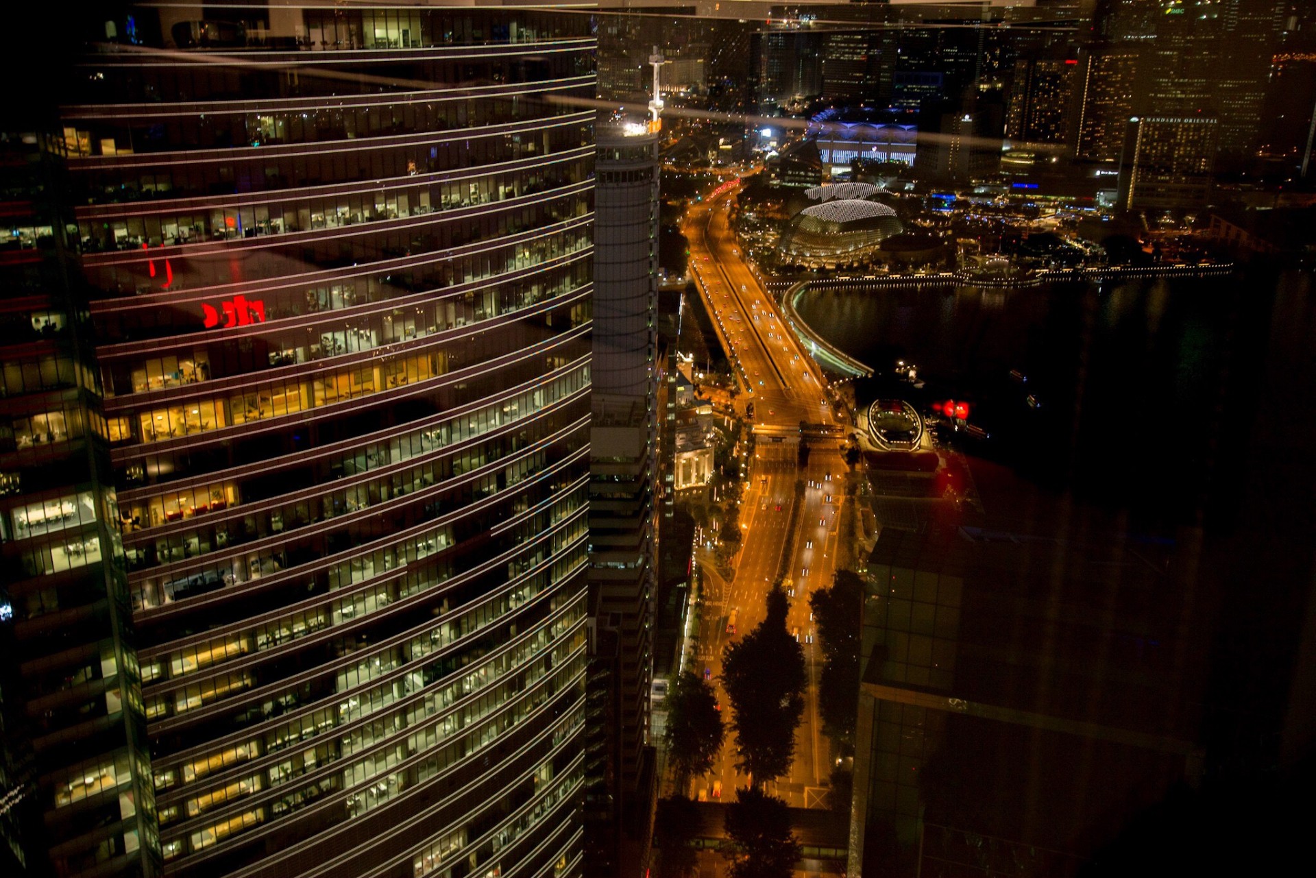 Modern cityscape at night with illuminated buildings and highways